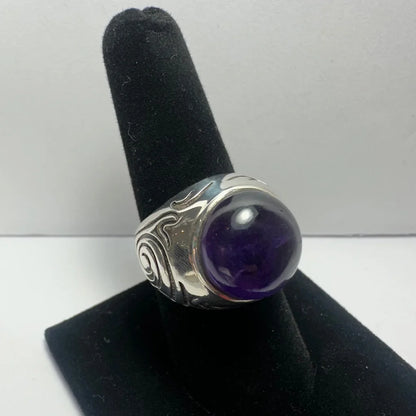 Stunning silver amethyst ring with swirling design and purple gem