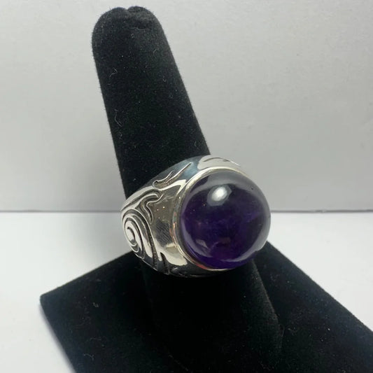 Stunning silver amethyst ring with swirling design and purple gem