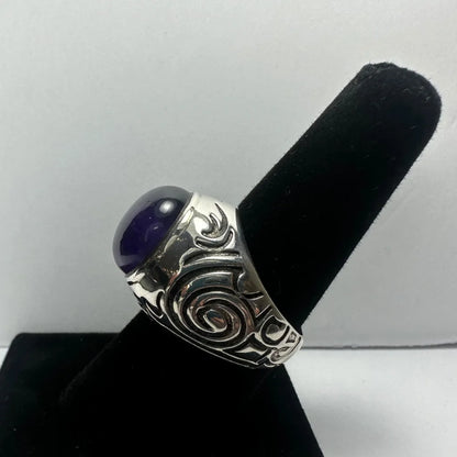 Stunning silver amethyst ring with swirling design and oval purple gem