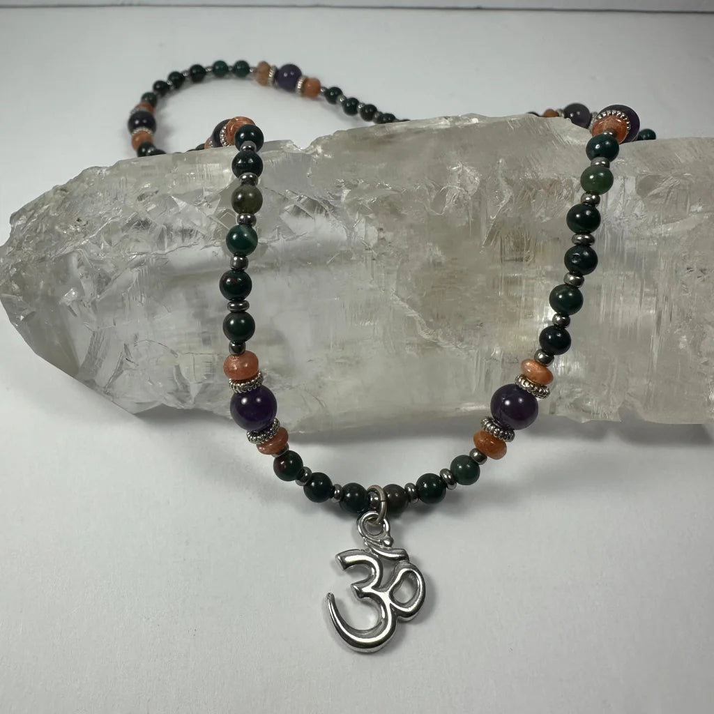 Stunning silver om pendant necklace with amethyst beads