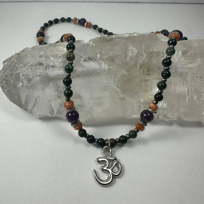 Stunning silver om pendant necklace with amethyst beads