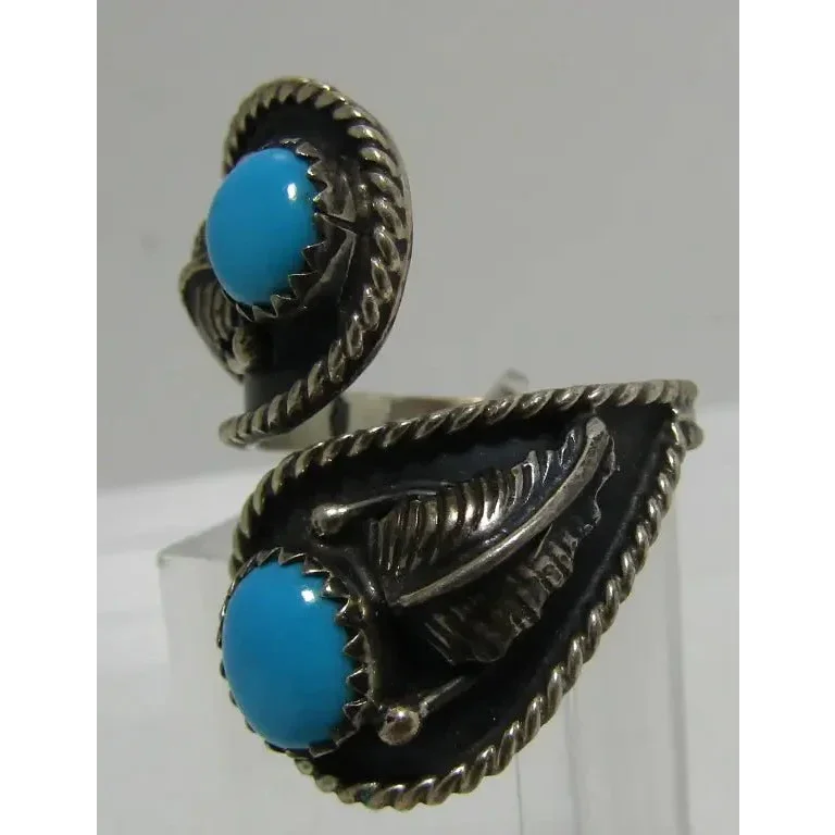 Sterling silver Native American-style turquoise ring set with Sleeping Beauty turquoise and feather accents