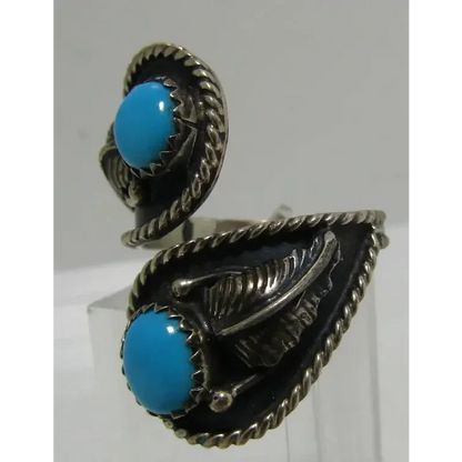 Sterling silver Native American-style turquoise ring set with Sleeping Beauty turquoise and feather accents