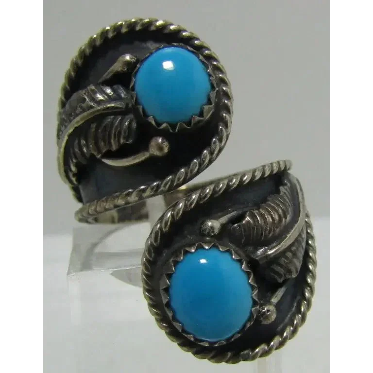 Sterling silver Native American earrings with Sleeping Beauty turquoise cabochons and feather accents