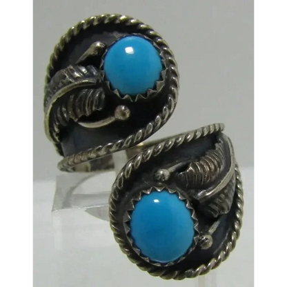 Sterling silver Native American earrings with Sleeping Beauty turquoise cabochons and feather accents