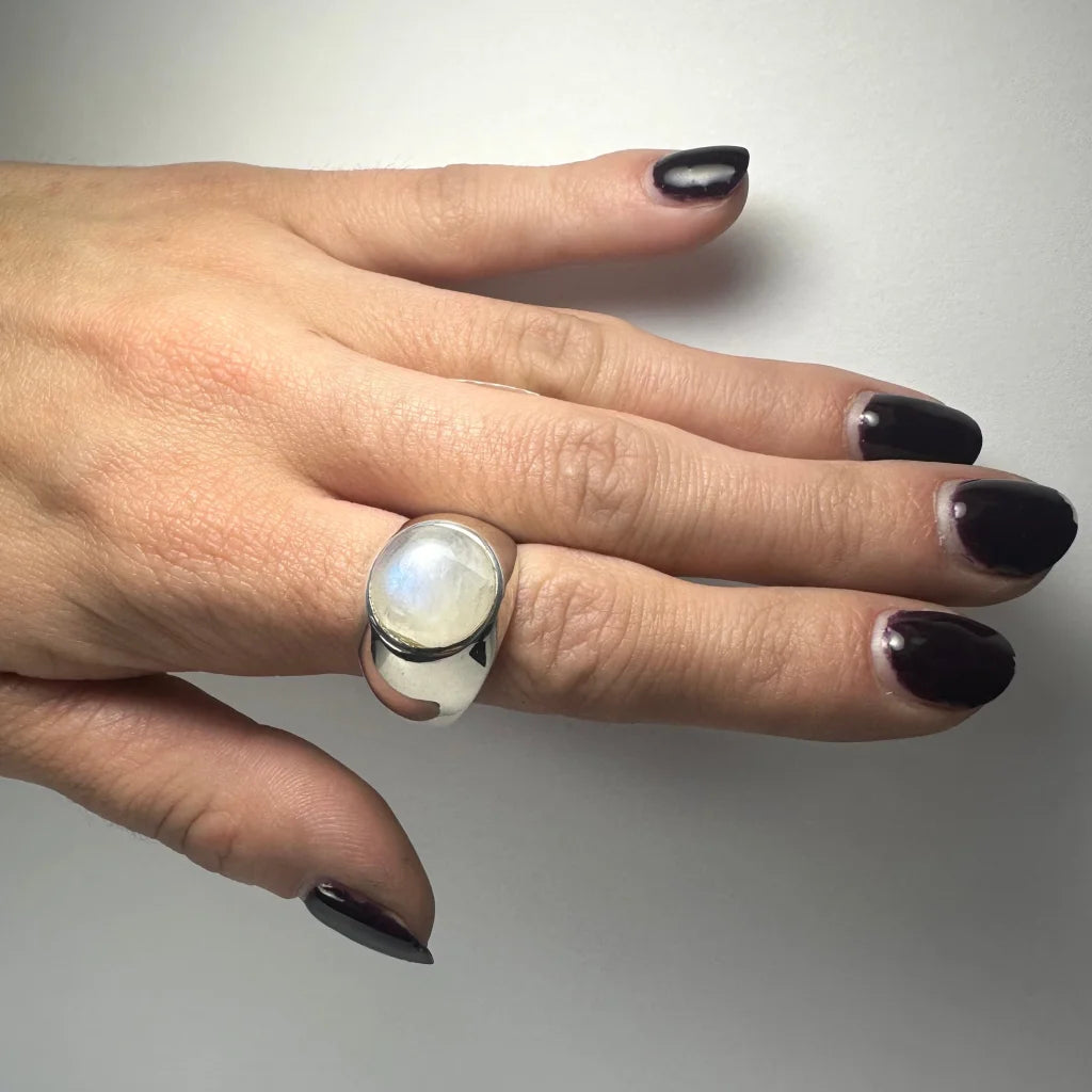 Sleek silver moonstone ring with oval iridescent glow