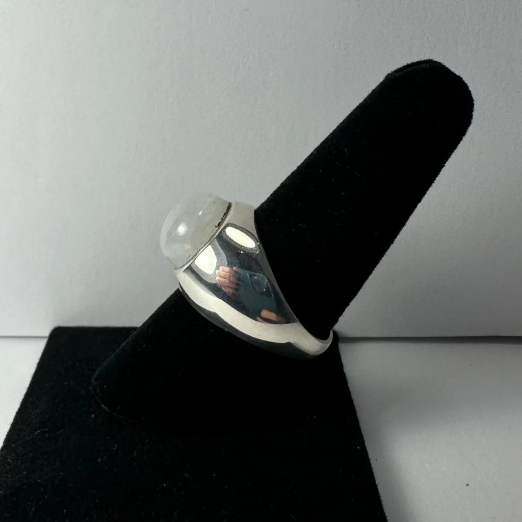 Sleek silver moonstone ring with iridescent glow and domed stone