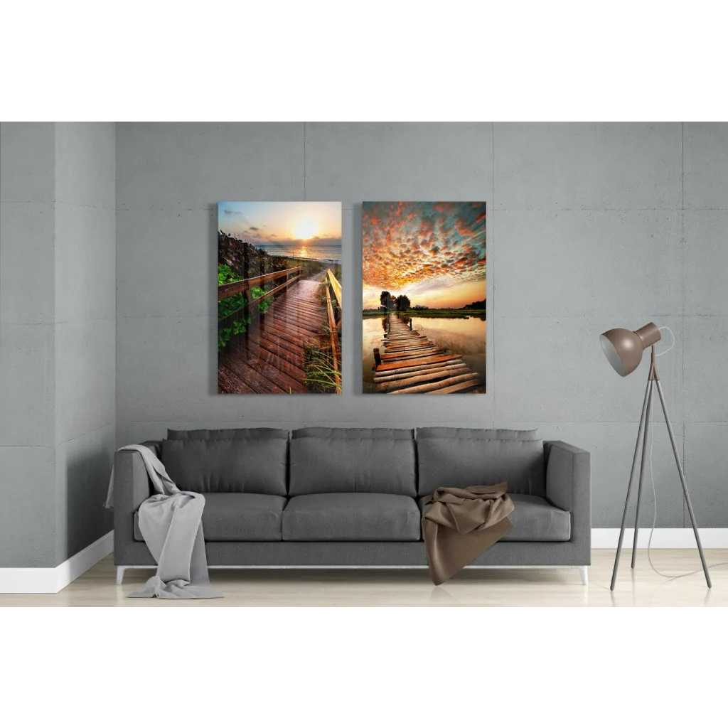 Cozy gray sofa with wooden legs and brown blanket, near Stunning Sunset Boardwalk glass wall art