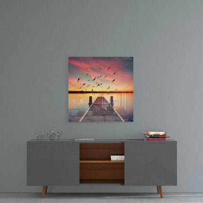 Modern gray sideboard with gold legs and open compartments below Stunning Sunset Dock glass wall art