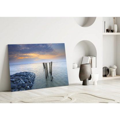 Stunning sunset glass wall art with ocean pier posts in blues and oranges