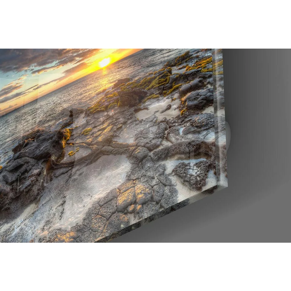 Stunning sunset glass wall art over rocky shore with sandy texture