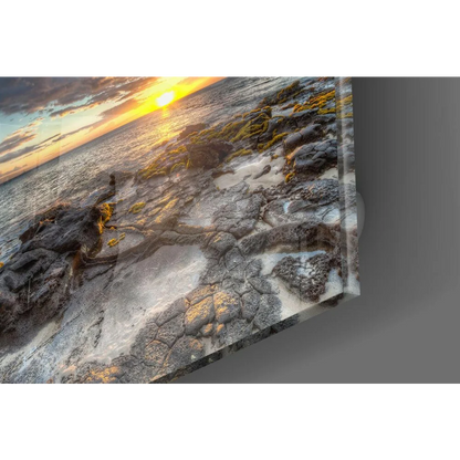 Stunning sunset glass wall art over rocky shore with sandy texture