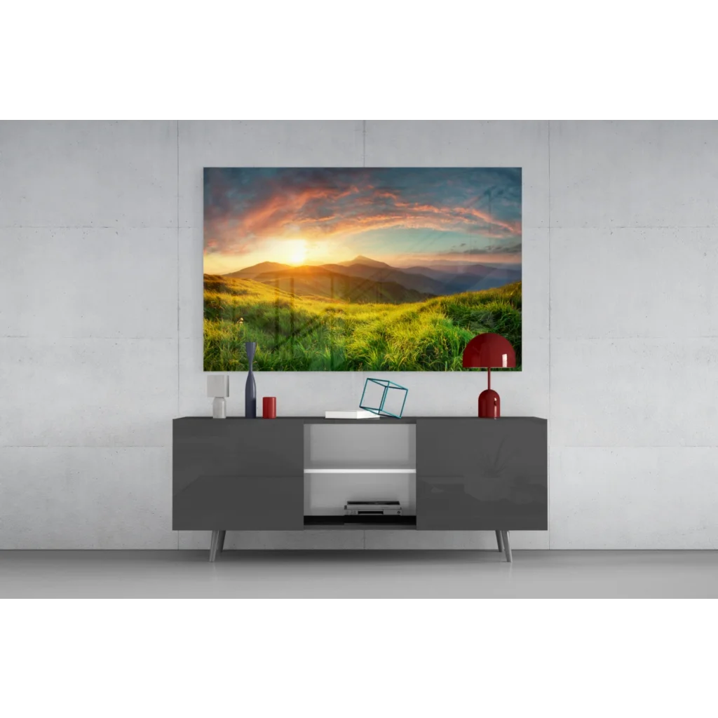 Vibrant sunset glass wall art over green hills on gray console