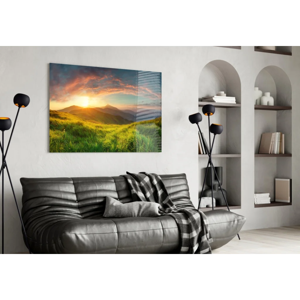 Stunning glass wall art of sunrise over green hills and orange pink skies