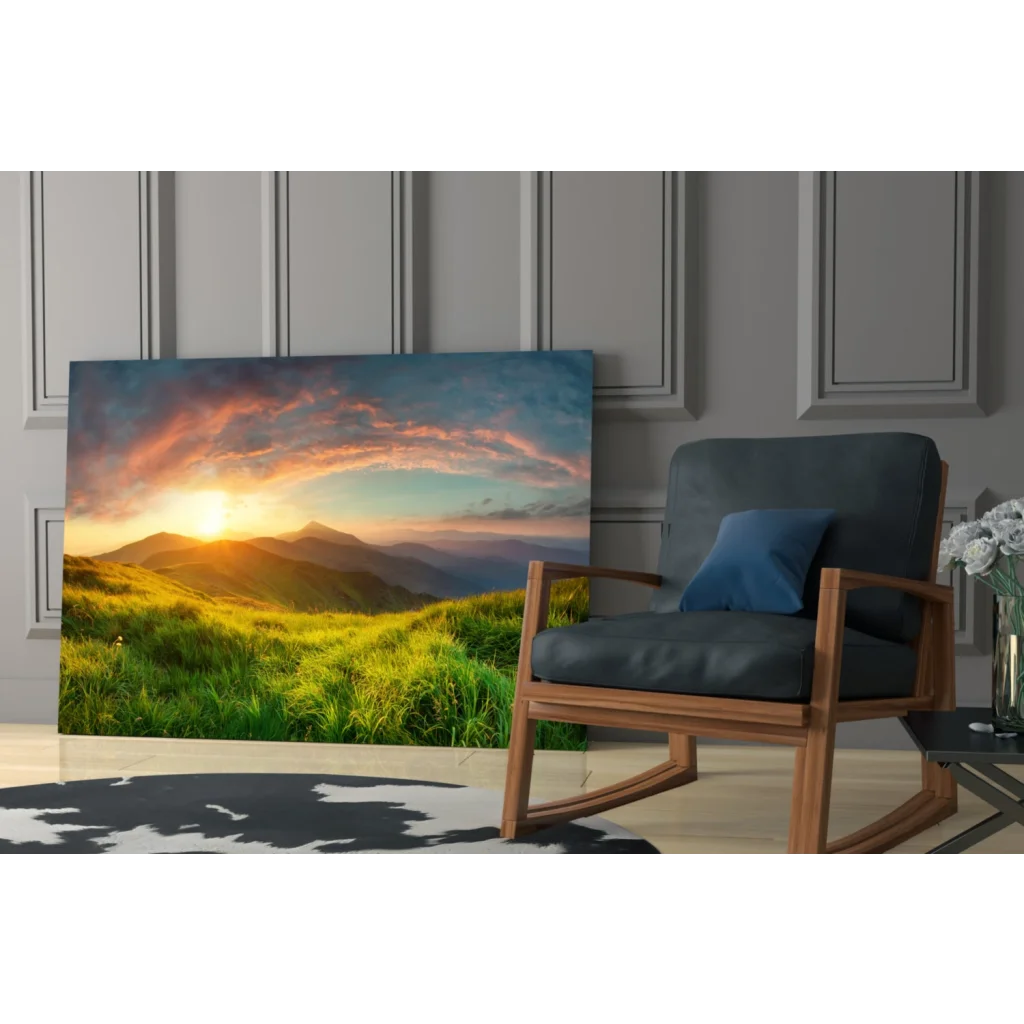 Vibrant sunset glass wall art over green hills and mountains