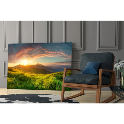 Vibrant sunset glass wall art over green hills and mountains