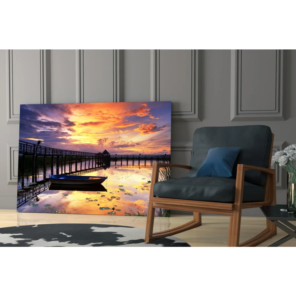 Vibrant sunset glass wall art of pier, boat, and water lilies