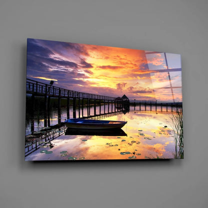Vibrant sunset glass wall art with pier, boat, and water lilies
