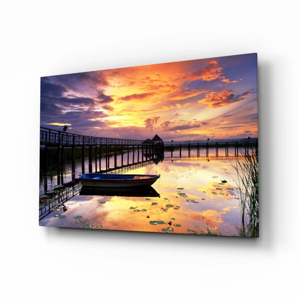 Vibrant sunset glass wall art of pier dock, boat, and lily pad water