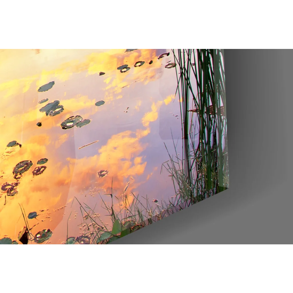 Serene sunset glass wall art with boat, water lilies and lily pads