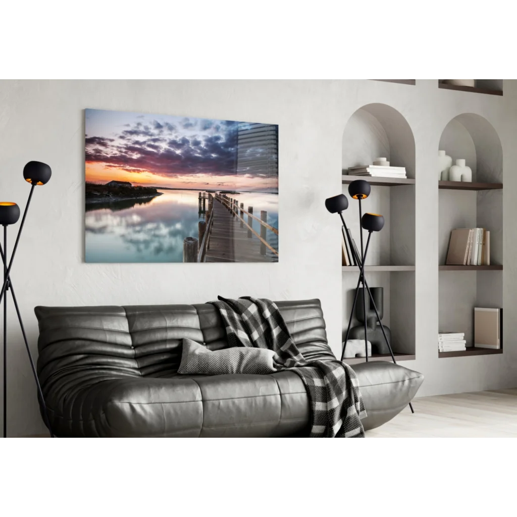 Leather sofa with checkered blanket and Stunning Sunset Pier wall art