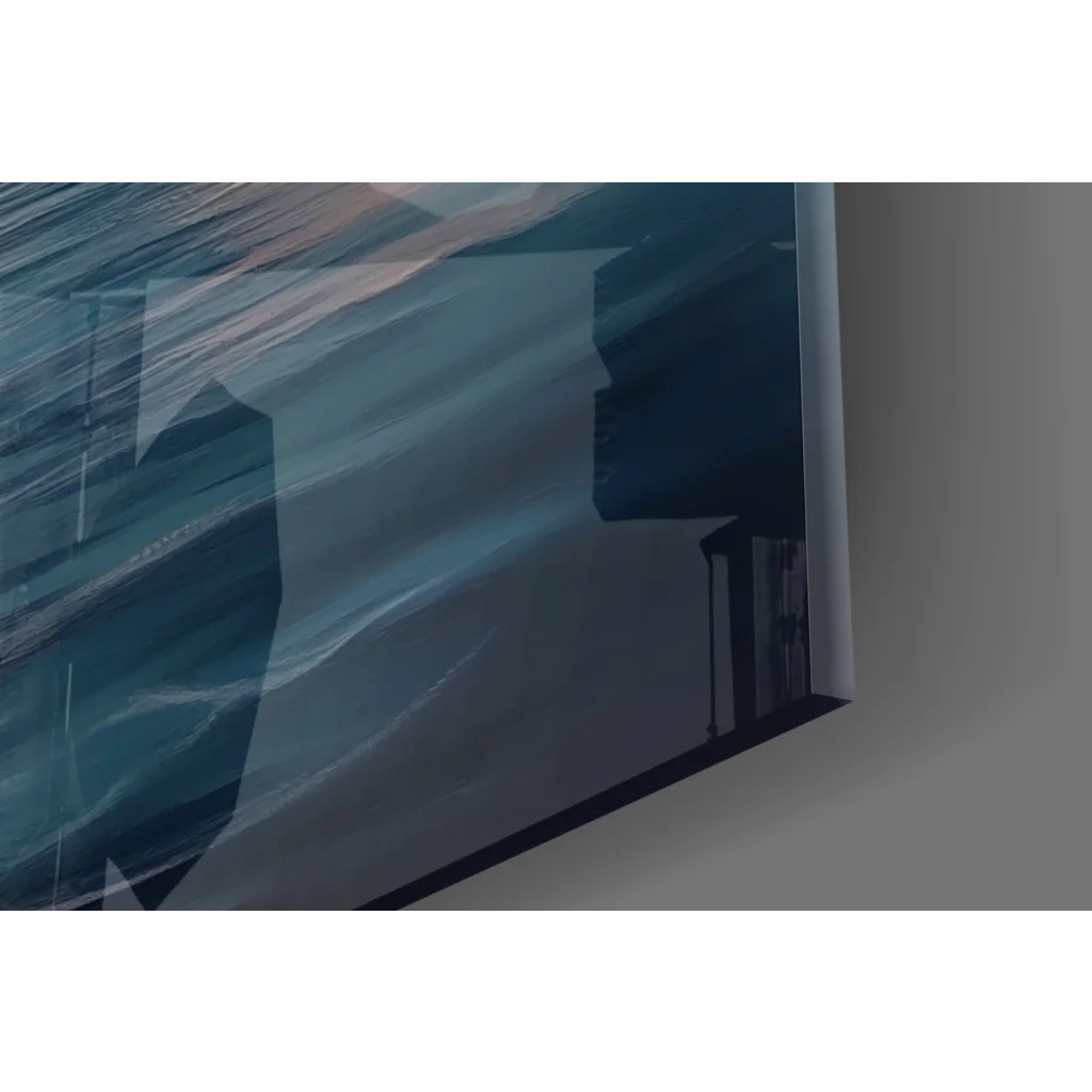 Blue geometric glass wall art print with sunset sailboat