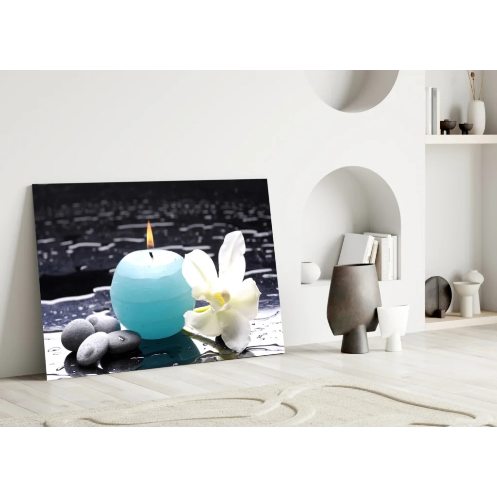 Teal candle with white orchid and pebbles in minimalist glass wall art