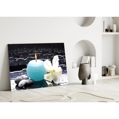 Teal candle with white orchid and pebbles in minimalist glass wall art