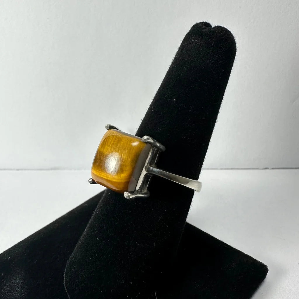 Bold tiger eye ring in sleek sterling silver band with prong details