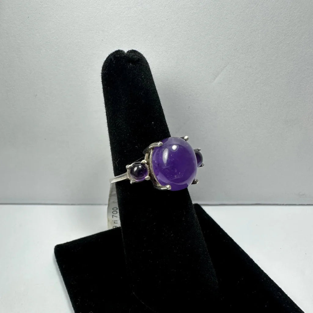 Stunning silver amethyst ring with oval purple gem and two round stones