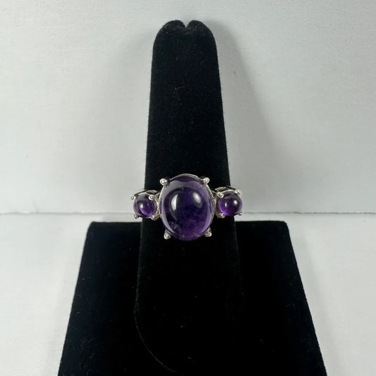 Stunning silver amethyst ring with oval center stone and two rounds