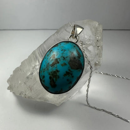 Stunning turquoise pendant in sterling silver with dark matrix inlay
