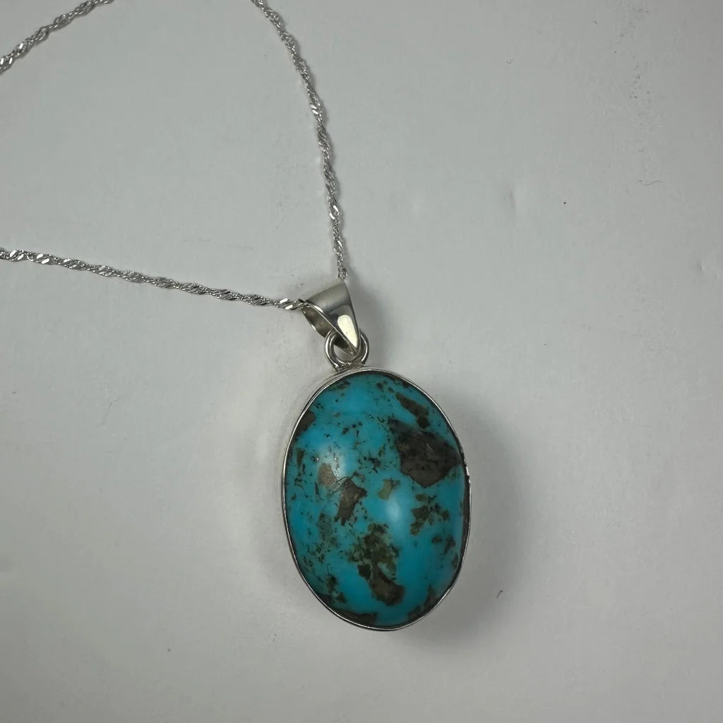 Stunning turquoise pendant in sterling silver with brown veining
