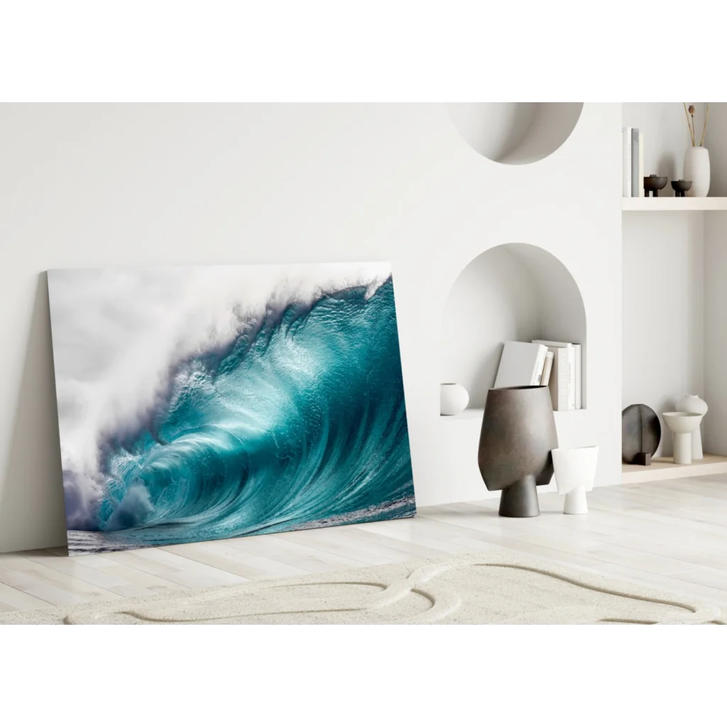 Vibrant turquoise ocean wave glass wall art leaning on white wall