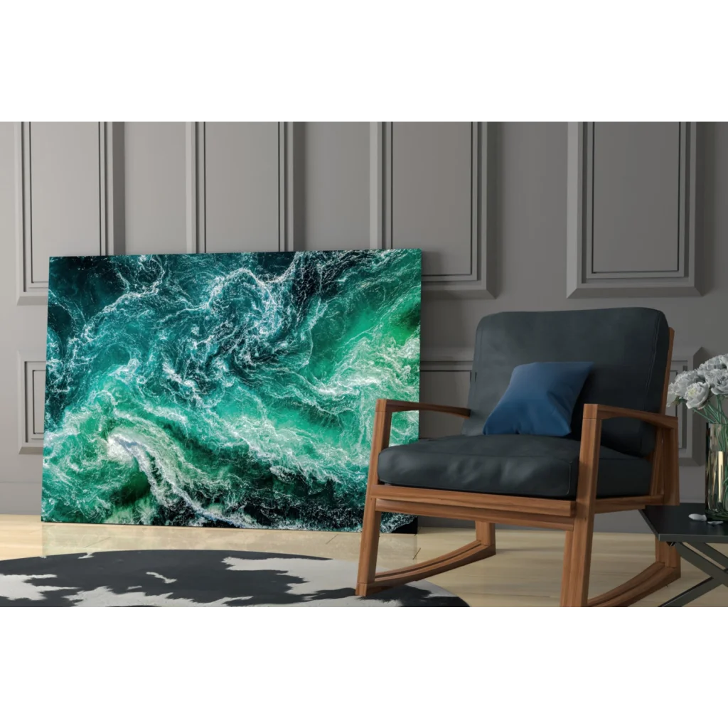 Vibrant teal wave glass wall art leaning on gray paneled wall