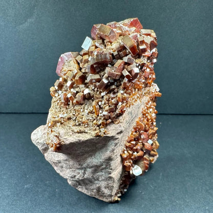 Stunning fiery cubic vanadinite cluster from Morocco on gray base