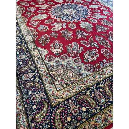 Vintage Kirman Persian rug with red navy paisley patterns and floral medallion