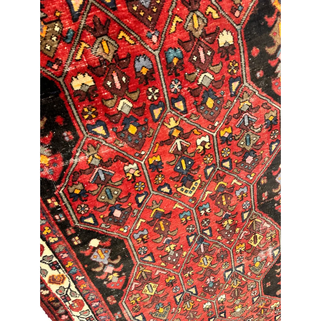 Vibrant vintage Persian Hosseinabad runner with red geometric floral patterns