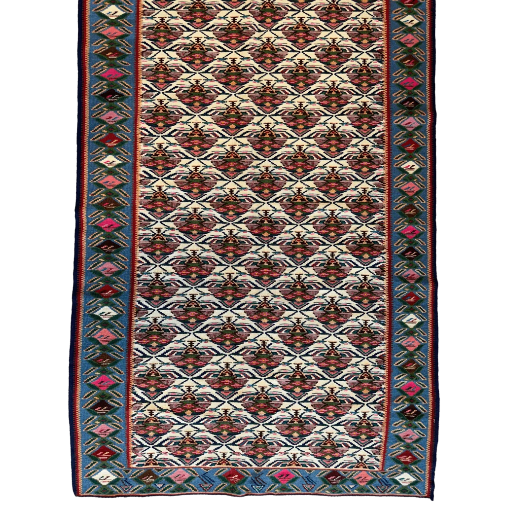 1980s Persian Senneh runner rug, close-up of geometric motifs, natural dye colors red blue and cream