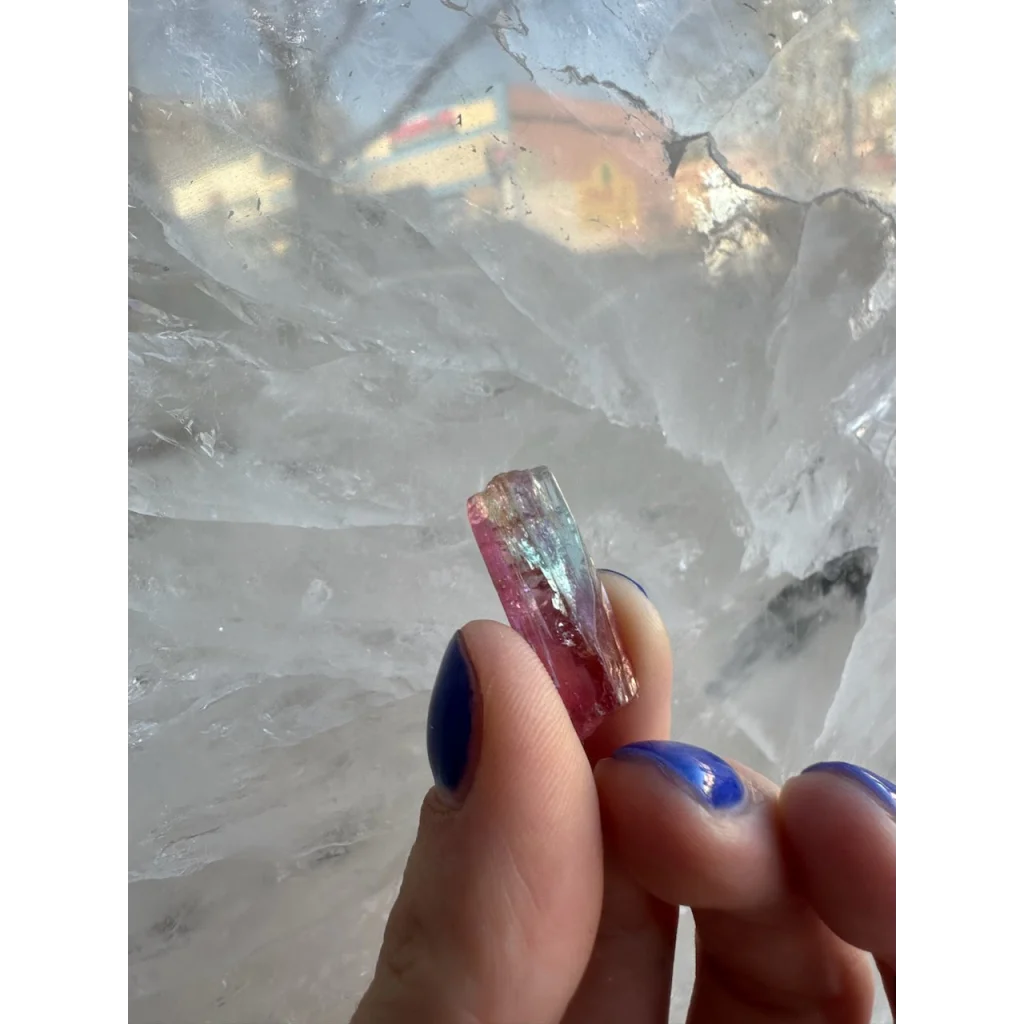 Stunning watermelon tourmaline crystal from Brazil held in fingers