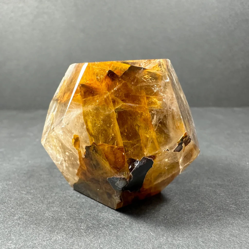 Stunning yellow hematoid quartz dodecahedron carving with amber inclusions