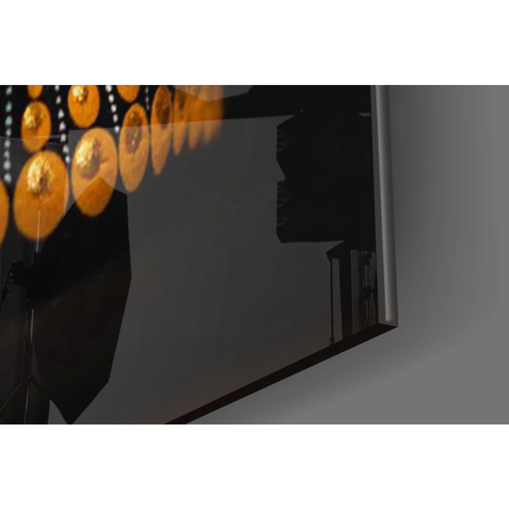 Sleek black-framed glass wall art print reflecting golden lights