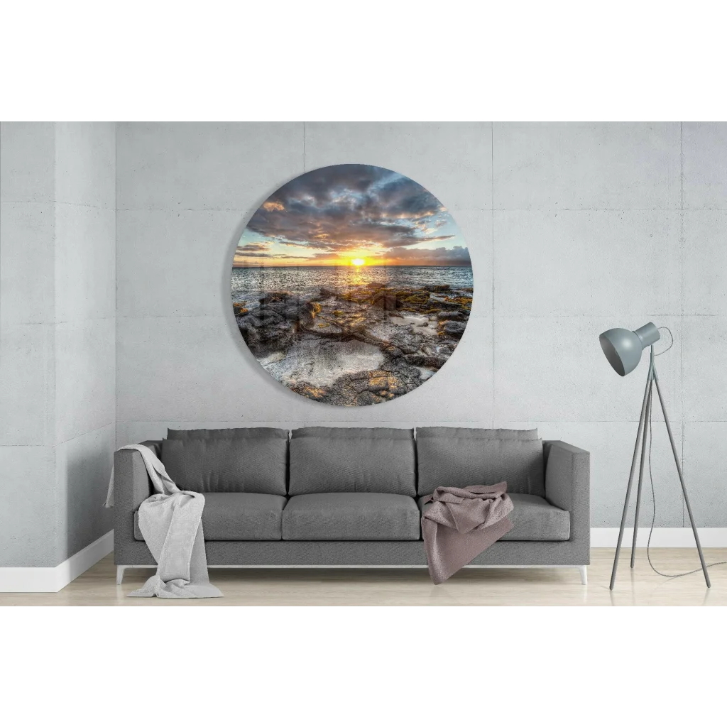 Vibrant sunset over rocky ocean in tempered glass art circle
