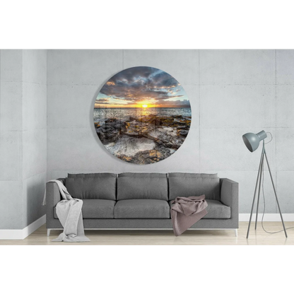 Vibrant sunset over rocky ocean in tempered glass art circle