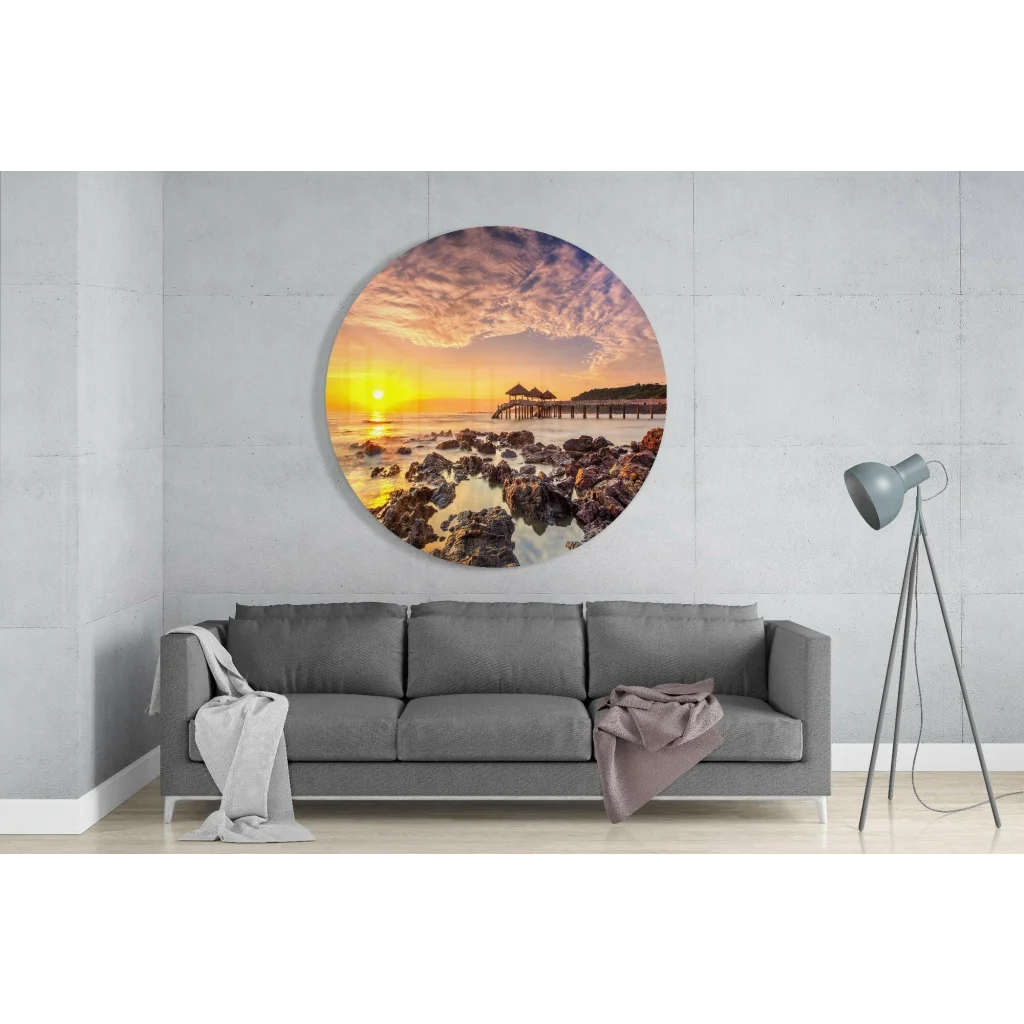 Vibrant sunset tempered glass art on rocky shore with pier