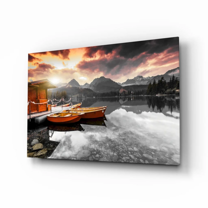 Serene sunset lake boats glass wall art with mountain views
