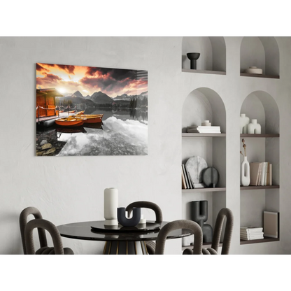 Vibrant sunset glass wall art with orange boats and mountain reflections