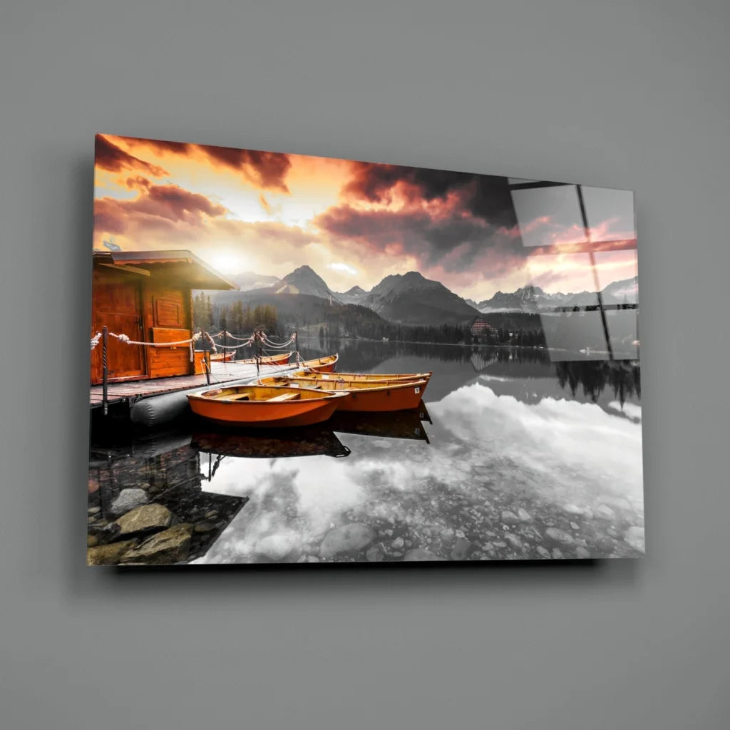 Serene sunset lake boats glass wall art with mountain views