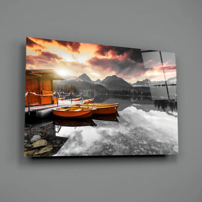 Serene sunset lake boats glass wall art with mountain views