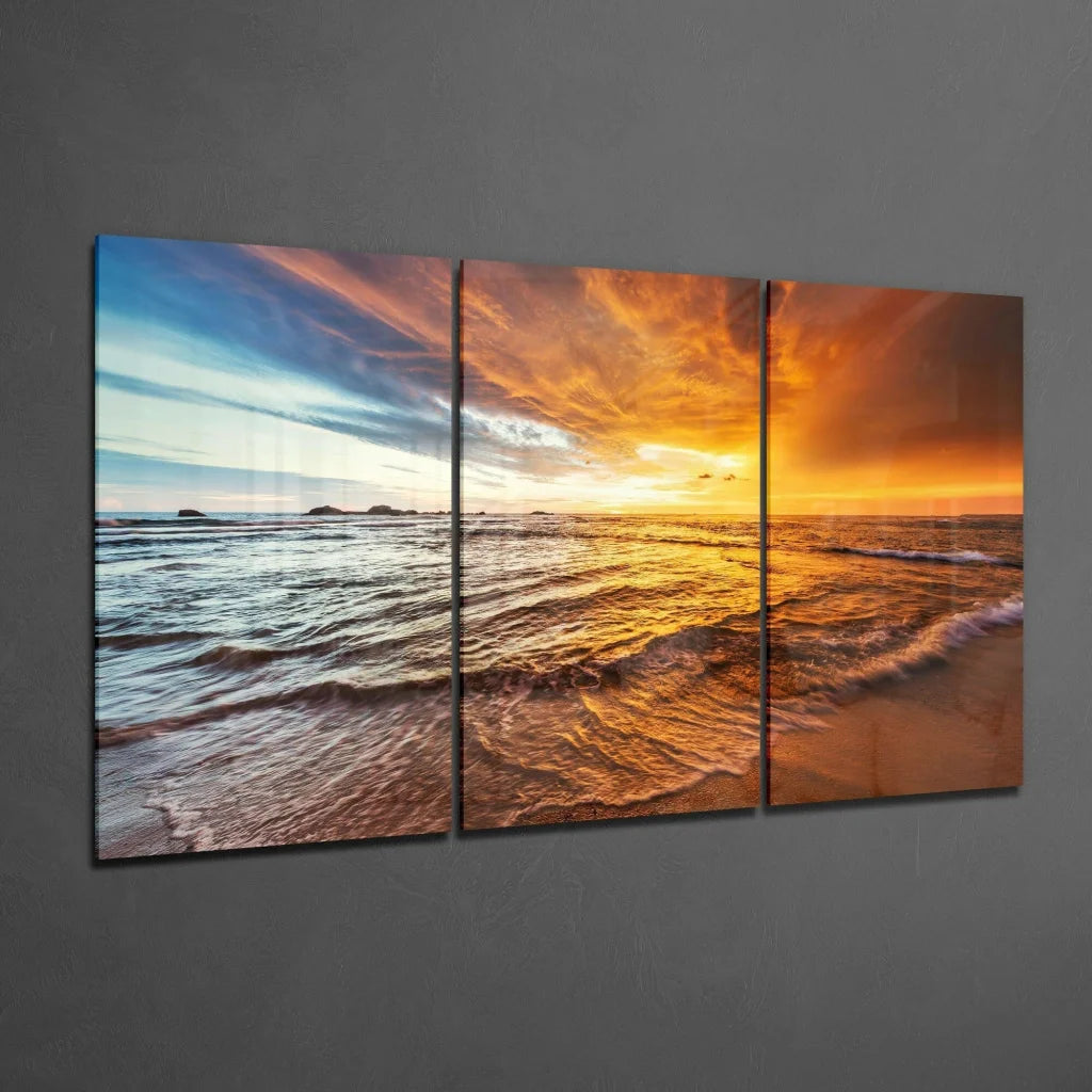 Vibrant orange sunset glass wall art with rippling ocean waves